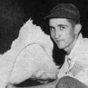 Old photo of a young, angular man in a dark baseball cap